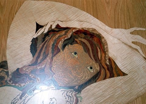 Détail de marqueterie, visage aux cheveux de bois